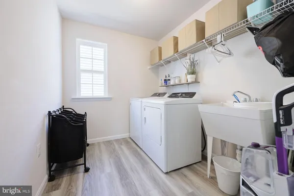 a utility room with sink dryer and washer