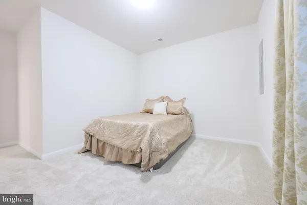 a spacious bedroom with a bed and a window