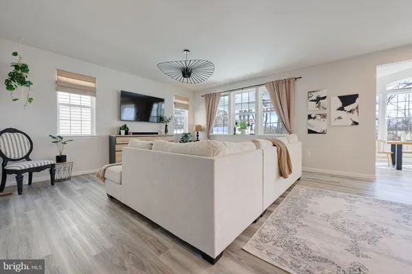 a view of a livingroom with furniture window and wooden floor
