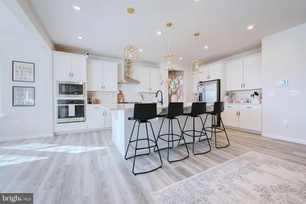 a living room with furniture and kitchen view