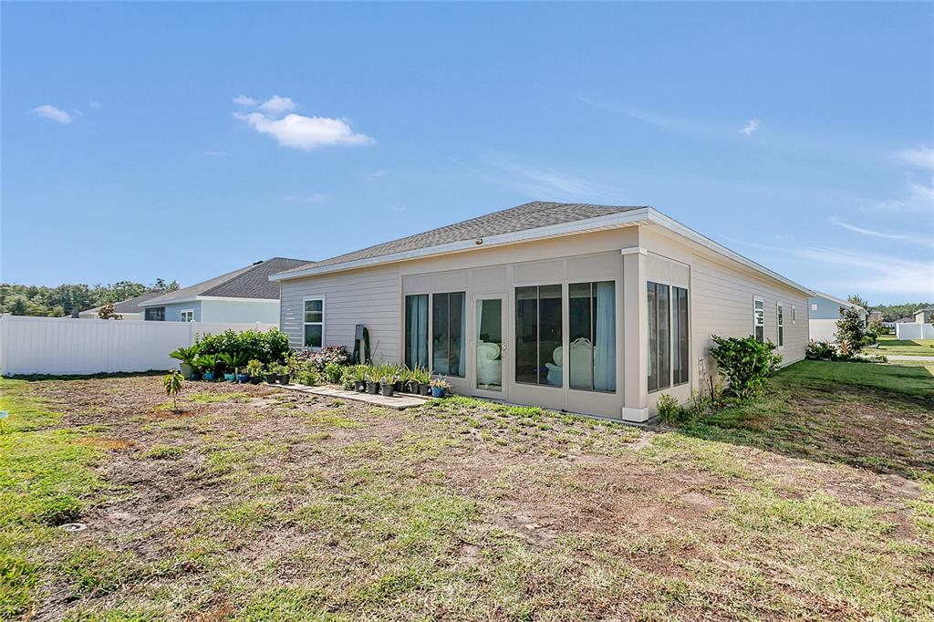 7507 Southwest 76th Terrace Ocala, FL 34476 - Photo 18 of 22 a front view of a house with garden