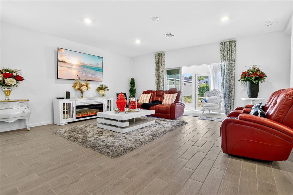 7507 Southwest 76th Terrace Ocala, FL 34476 - Photo 5 of 22 a living room with furniture and a flat screen tv