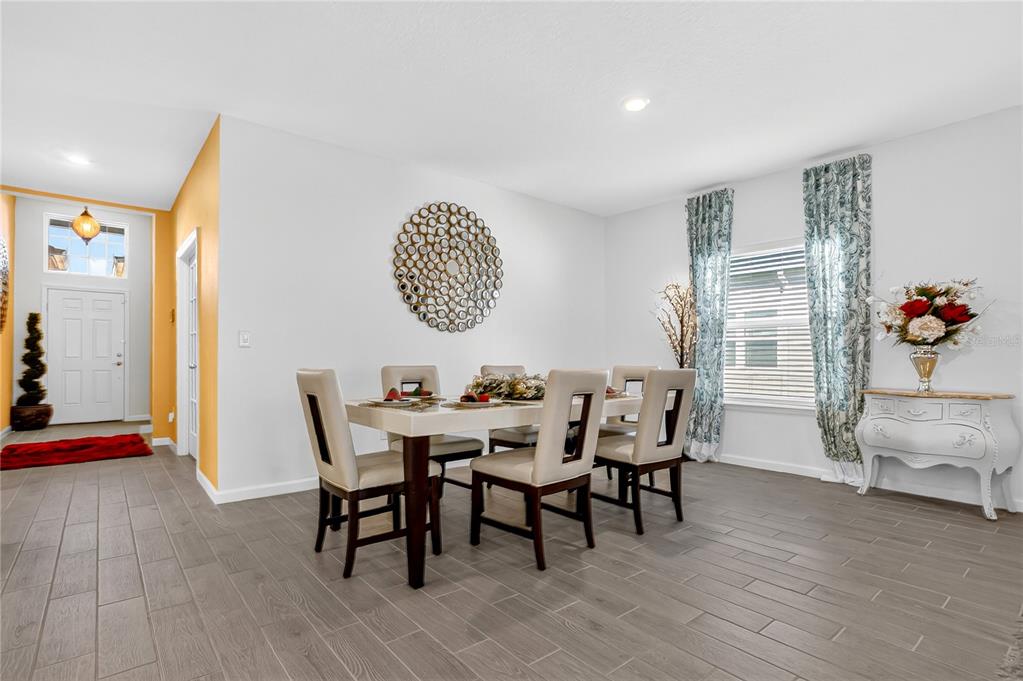 7507 Southwest 76th Terrace Ocala, FL 34476 - Photo 7 of 22 a view of a dining room with furniture and wooden floor
