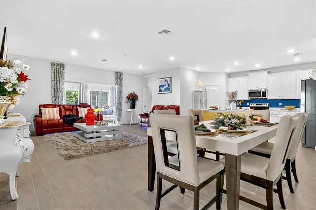 a kitchen with stainless steel appliances a stove a sink a refrigerator and a refrigerator