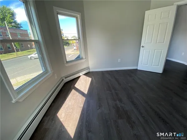 a view of an entryway with wooden floor