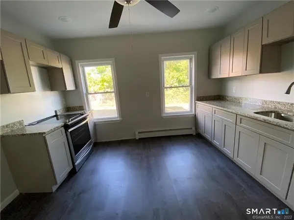 a kitchen with a sink a microwave and cabinets