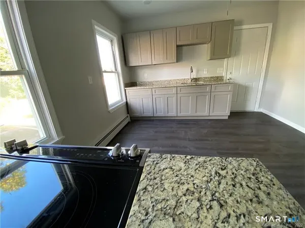a kitchen with a sink window and cabinets