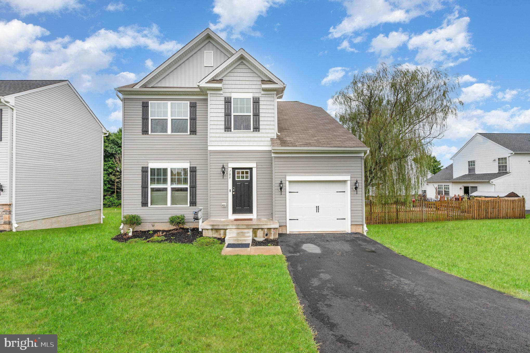 105 Maple Leaf Drive Rising Sun, MD 21911 - Photo 1 of 31 a front view of a house with a garden and trees