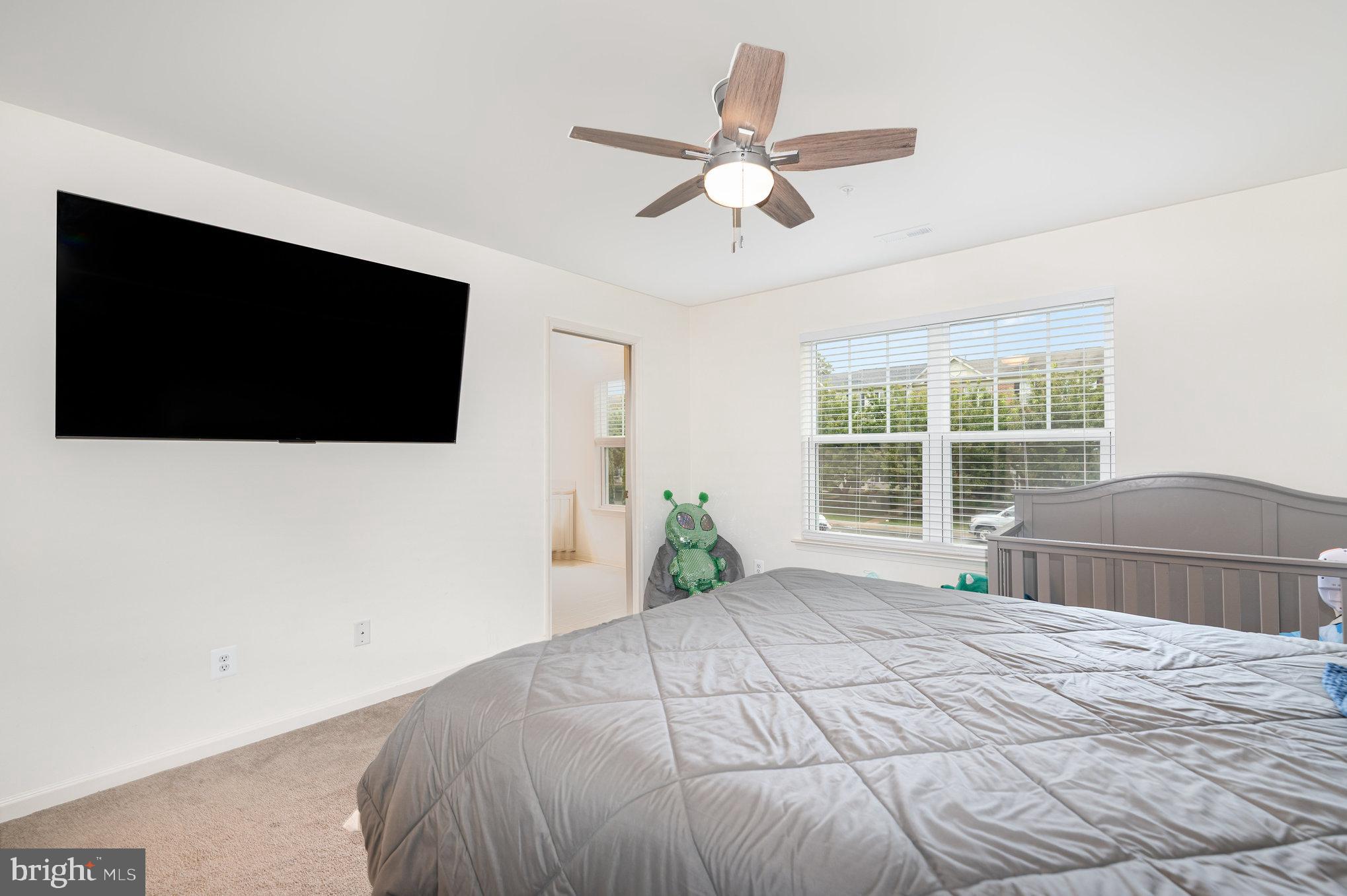 105 Maple Leaf Drive Rising Sun, MD 21911 - Photo 14 of 31 a bedroom with a bed and a flat screen tv