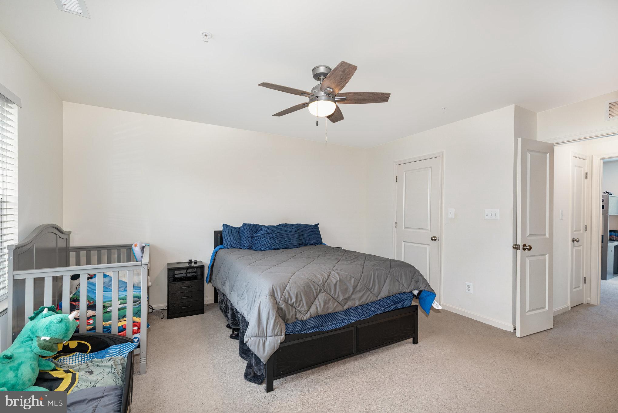 105 Maple Leaf Drive Rising Sun, MD 21911 - Photo 15 of 31 a bedroom with a bed and a chandelier