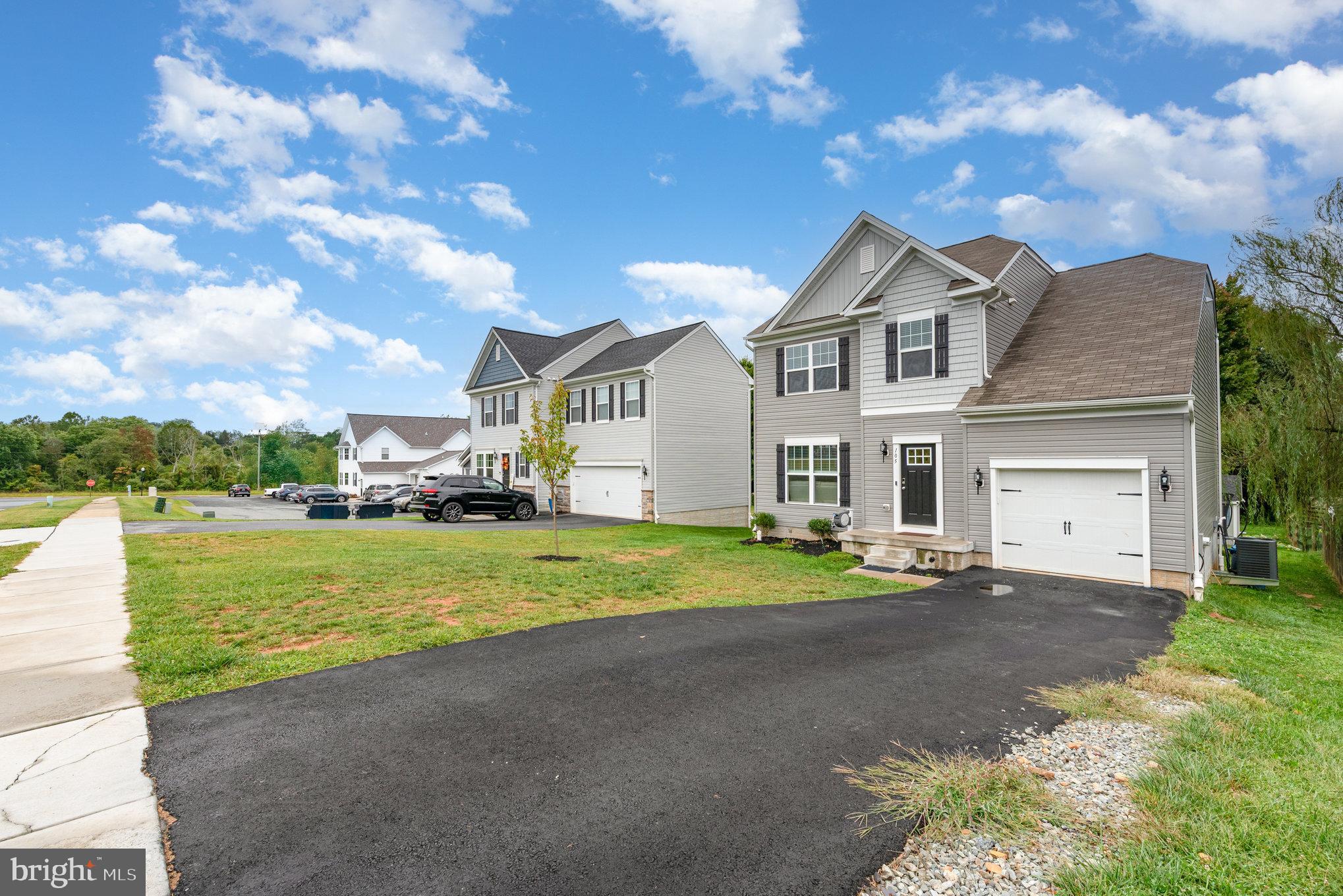 105 Maple Leaf Drive Rising Sun, MD 21911 - Photo 31 of 31 a front view of a house with a yard and garage