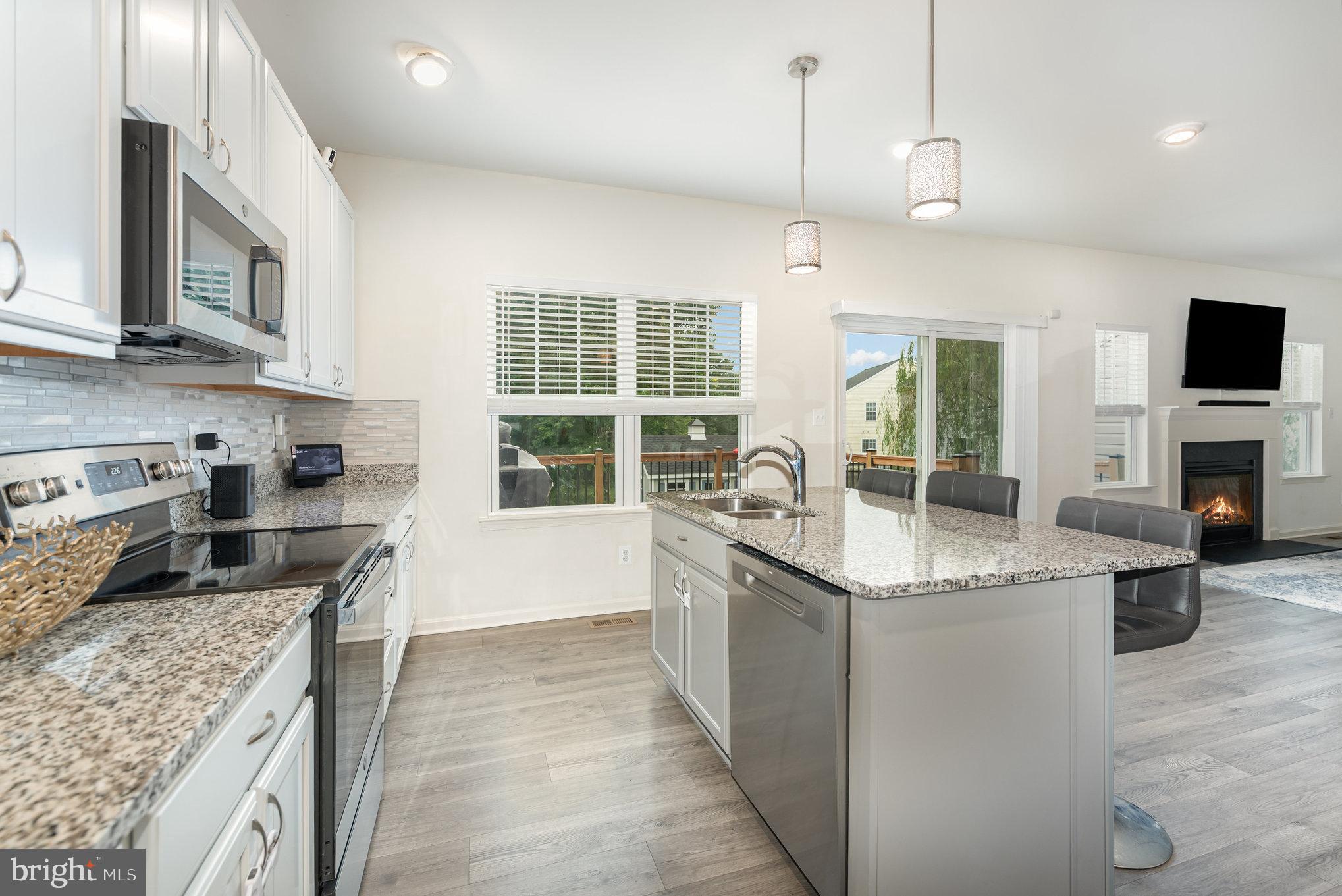 105 Maple Leaf Drive Rising Sun, MD 21911 - Photo 9 of 31 a kitchen with stainless steel appliances granite countertop a sink stove and refrigerator