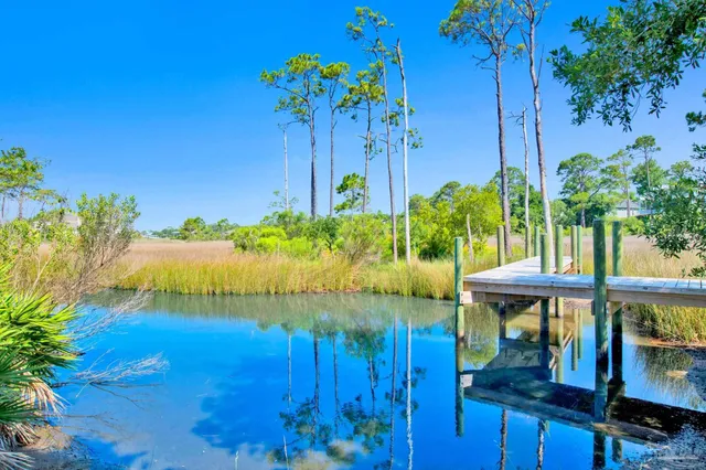 a view of a living room with furniture and kitchen view