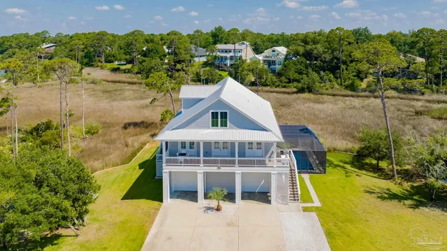 an aerial view of a house with a lake view