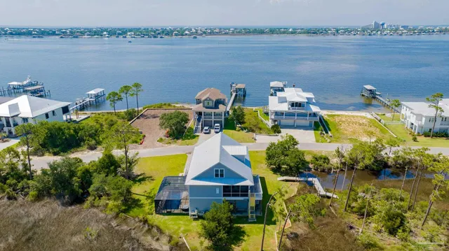 an aerial view of a house with a lake view
