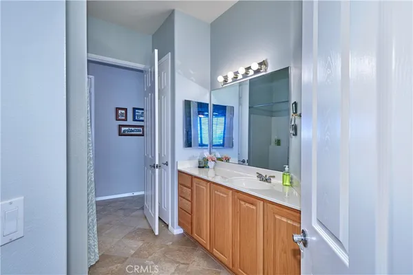 a bathroom with a double vanity sink and a mirror