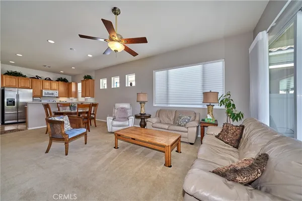 a kitchen with stainless steel appliances granite countertop a refrigerator a sink dishwasher a stove with wooden cabinets and floor