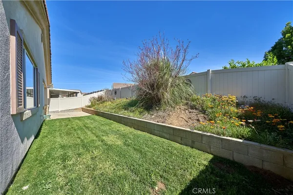 a living room with furniture a ceiling fan and a large window