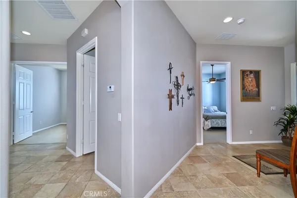 a view of a livingroom with a dinning area wooden floor and windows