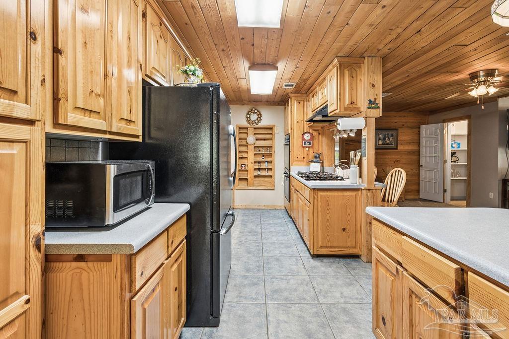 8938 Pioneer Road Holt, FL 32564 - Photo 14 of 44 a kitchen with stainless steel appliances granite countertop a refrigerator a stove and a sink with cabinets