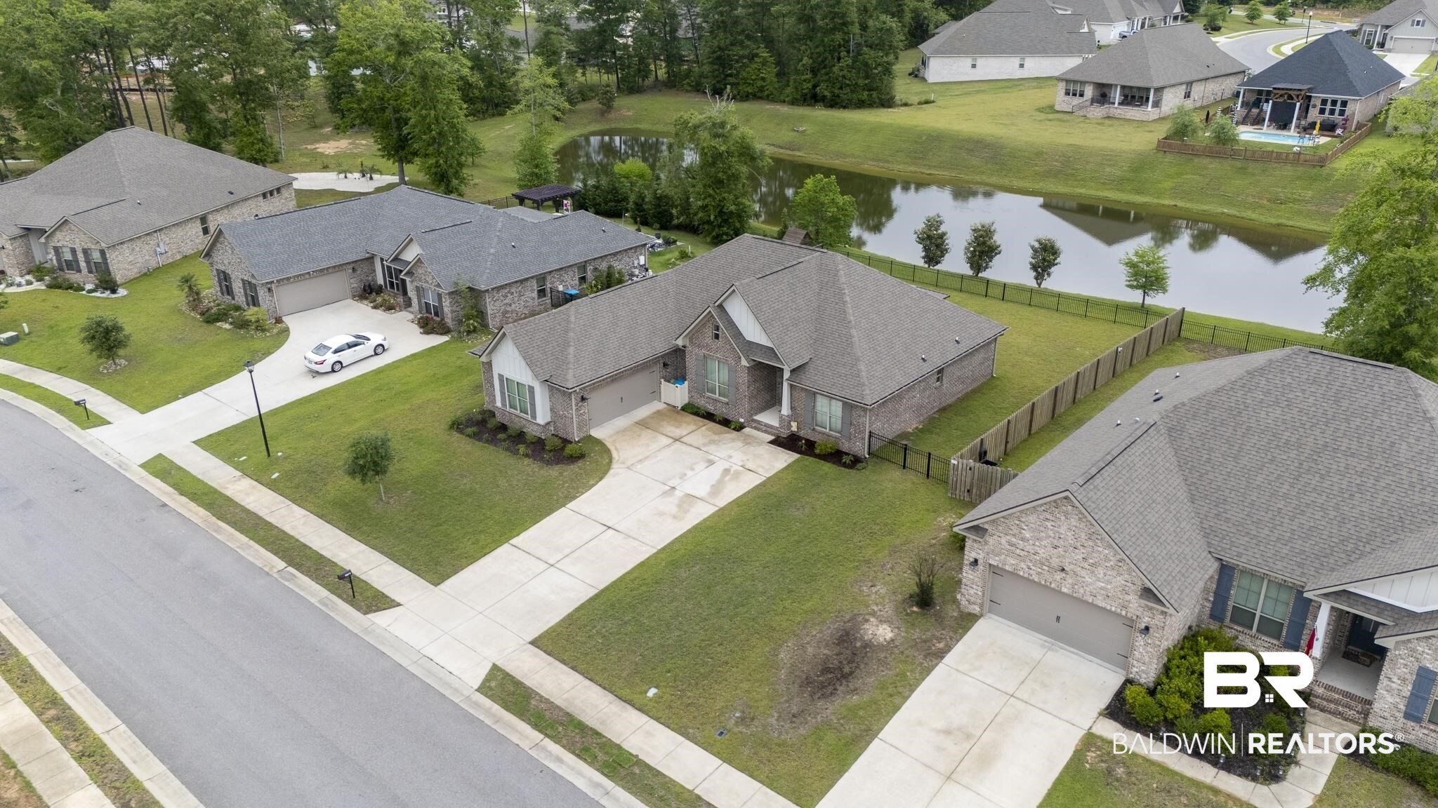 12672 Squirrel Drive Daphne, AL 36527 - Photo 43 of 49 Brick exterior featuring gray siding accents, an attached two-car garage, and a concrete driveway
