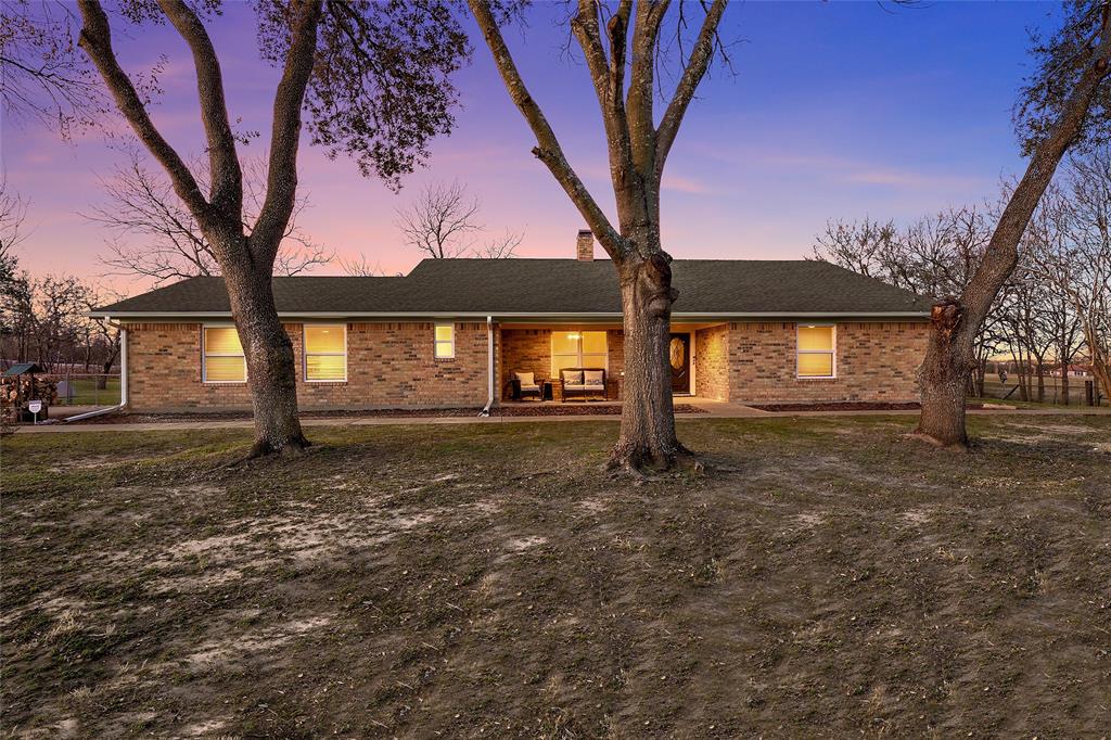 Ranch-style house with brick siding and roof with shingles