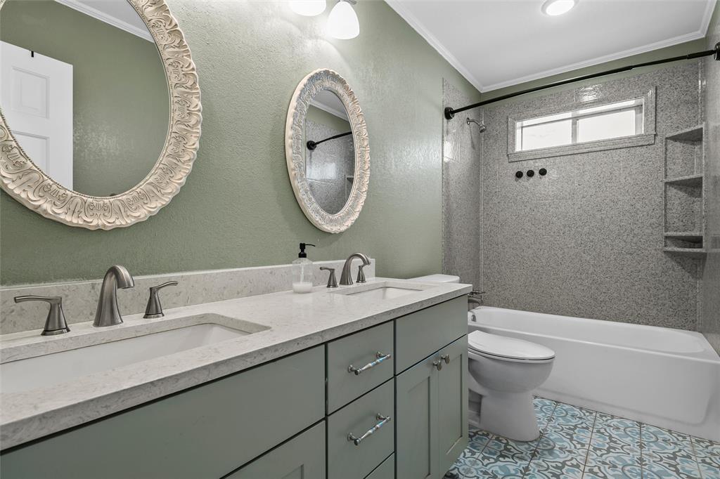107 South Old Robinson Road Robinson, TX 76706 - Photo 25 of 39 Full bath with a textured wall, double vanity, ornamental molding, and shower / bathtub combination
