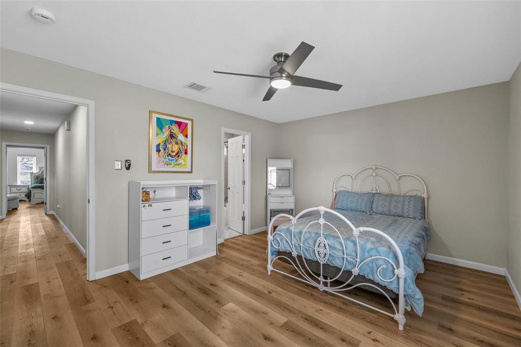 107 South Old Robinson Road Robinson, TX 76706 - Photo 27 of 39 Bedroom featuring light wood finished floors, a ceiling fan, and ensuite bathroom