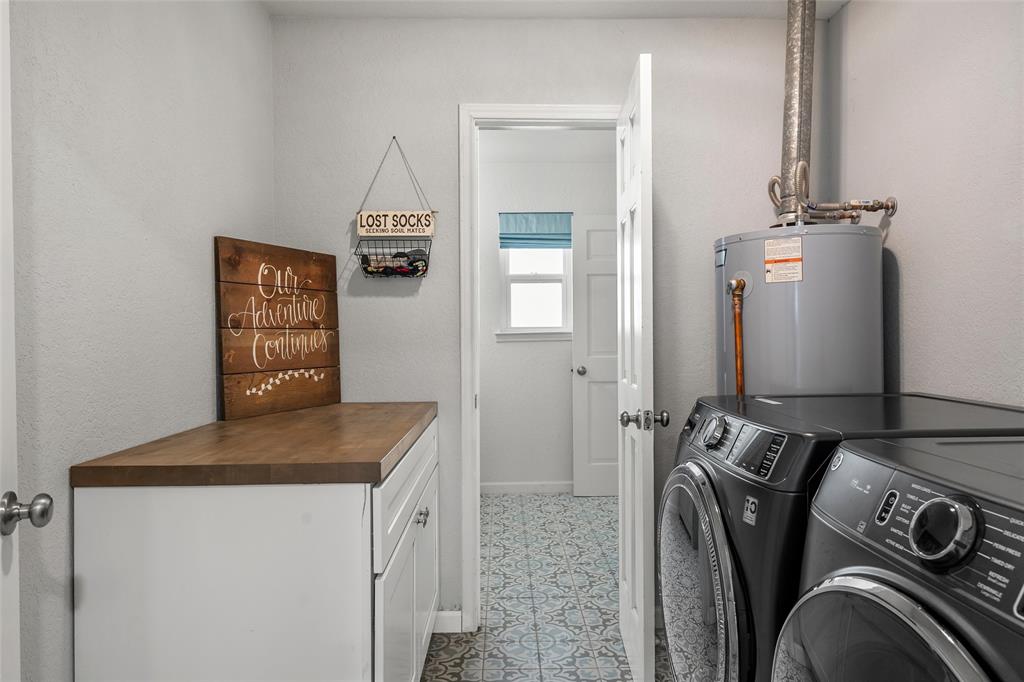 107 South Old Robinson Road Robinson, TX 76706 - Photo 28 of 39 Laundry area with gas water heater, washing machine and clothes dryer, and cabinet space