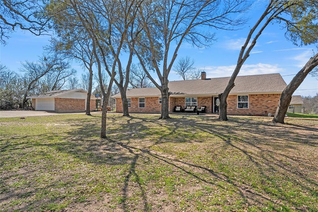107 South Old Robinson Road Robinson, TX 76706 - Photo 3 of 39 Ranch-style home featuring brick siding, a chimney, a front yard, and an outbuilding