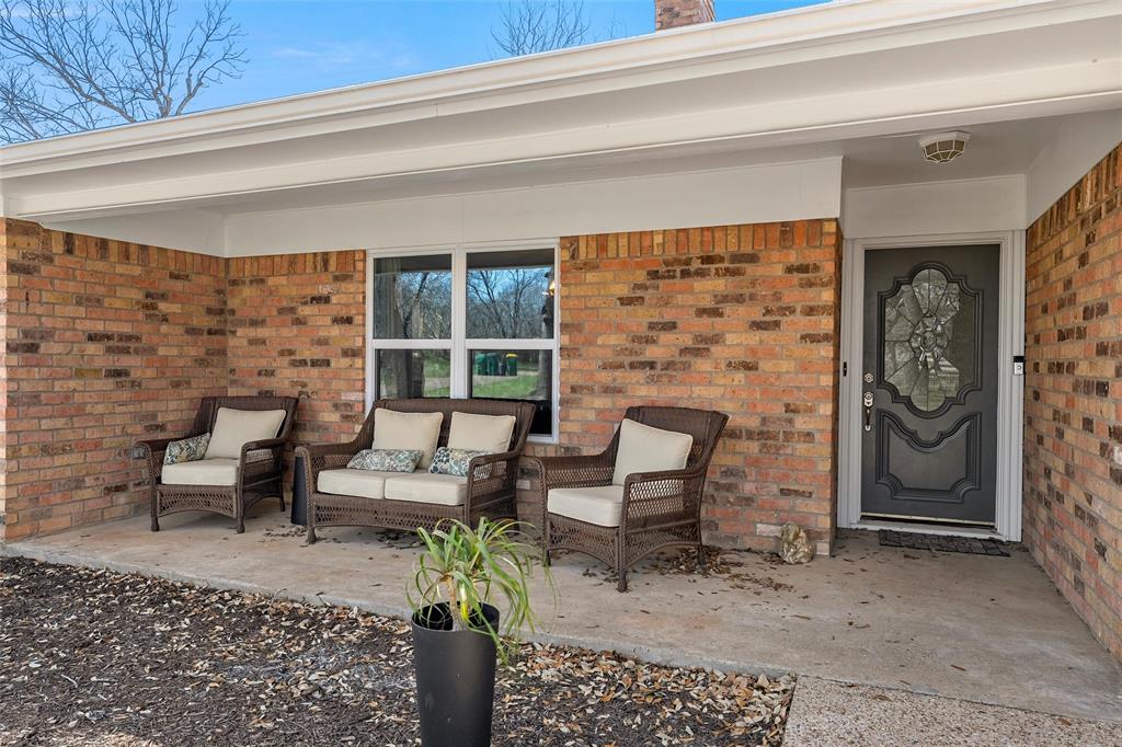 107 South Old Robinson Road Robinson, TX 76706 - Photo 5 of 39 View of exterior entry featuring brick siding and a patio