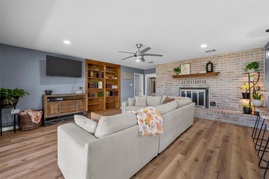107 South Old Robinson Road Robinson, TX 76706 - Photo 7 of 39 Living room with ceiling fan, a brick fireplace, light wood-style flooring, and recessed lighting