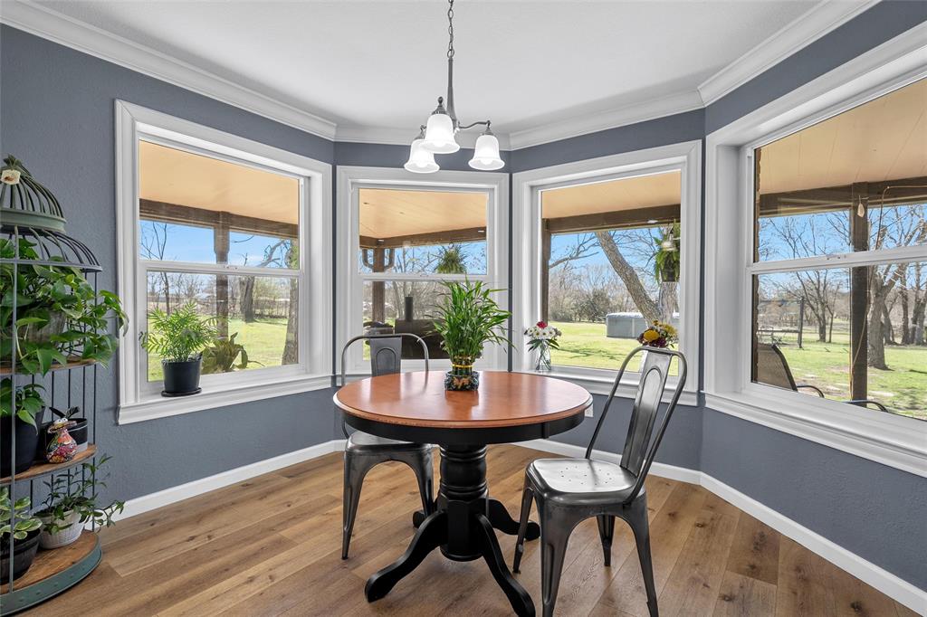 107 South Old Robinson Road Robinson, TX 76706 - Photo 8 of 39 Dining space with hardwood / wood-style flooring, suspended lighting, and crown molding