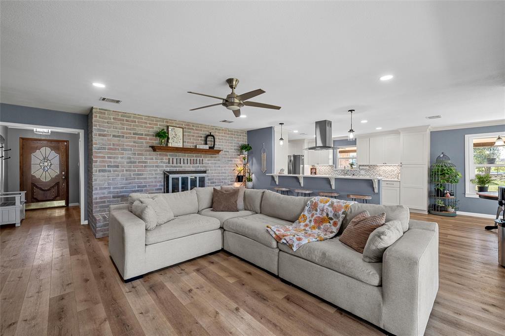 107 South Old Robinson Road Robinson, TX 76706 - Photo 10 of 39 Living room featuring a ceiling fan, light wood-type flooring, a brick fireplace, and recessed lighting
