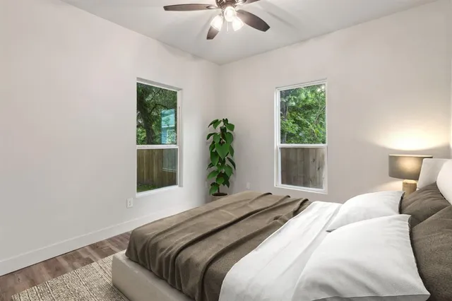 a bedroom with a large bed and a chandelier