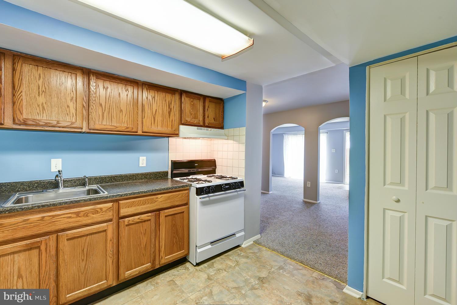 2360 Sun Valley Circle, Unit 2GH Silver Spring, MD 20906 - Photo 13 of 30 a kitchen with stainless steel appliances granite countertop a stove a sink and a microwave