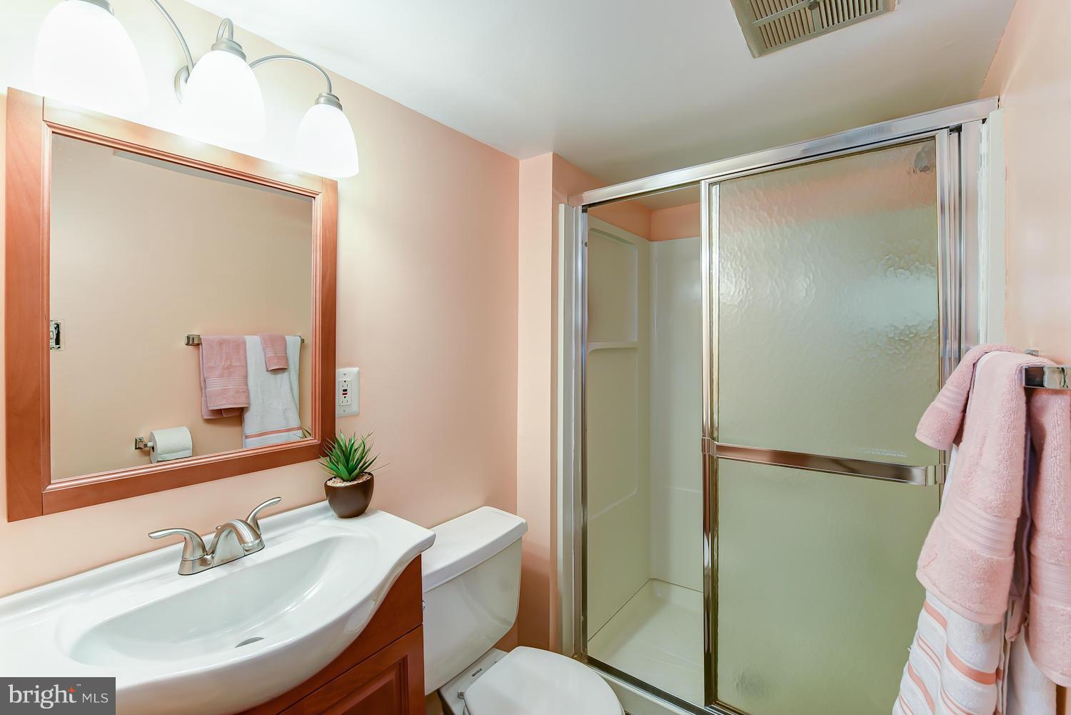 2360 Sun Valley Circle, Unit 2GH Silver Spring, MD 20906 - Photo 20 of 30 a bathroom with a sink mirror toilet and shower