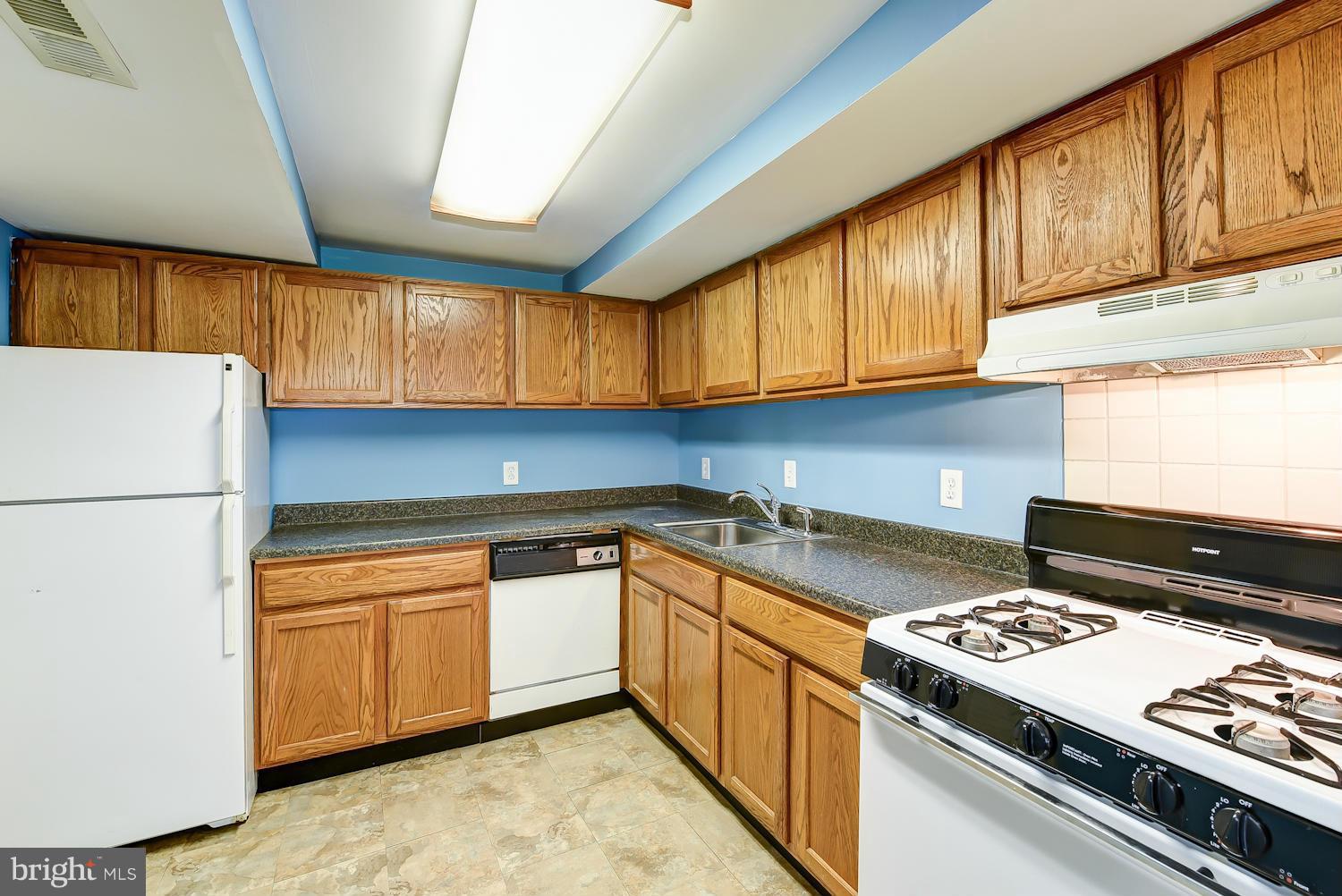 2360 Sun Valley Circle, Unit 2GH Silver Spring, MD 20906 - Photo 8 of 30 a kitchen with kitchen island a sink stove and refrigerator