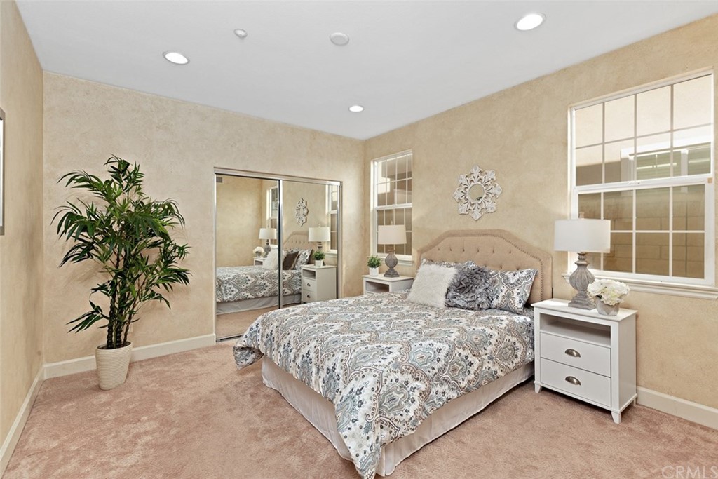 720 West Aster Place Santa Ana, CA 92706 - Photo 13 of 41 a bedroom with a large bed and a potted plant