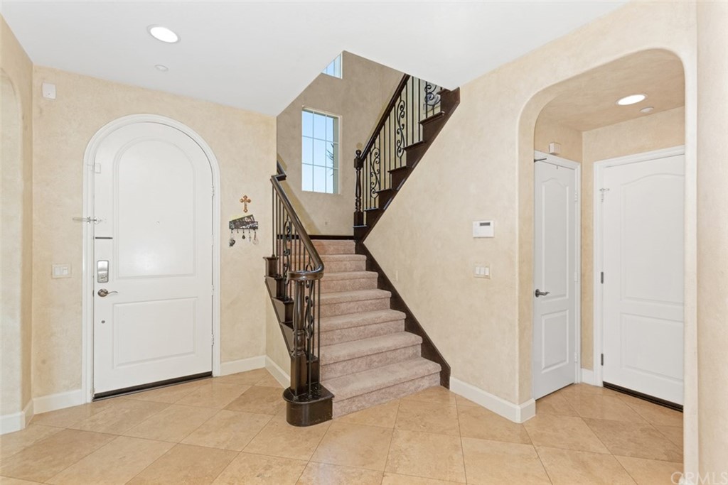 720 West Aster Place Santa Ana, CA 92706 - Photo 17 of 41 a view of a hallway with entryway wooden floor and staircase