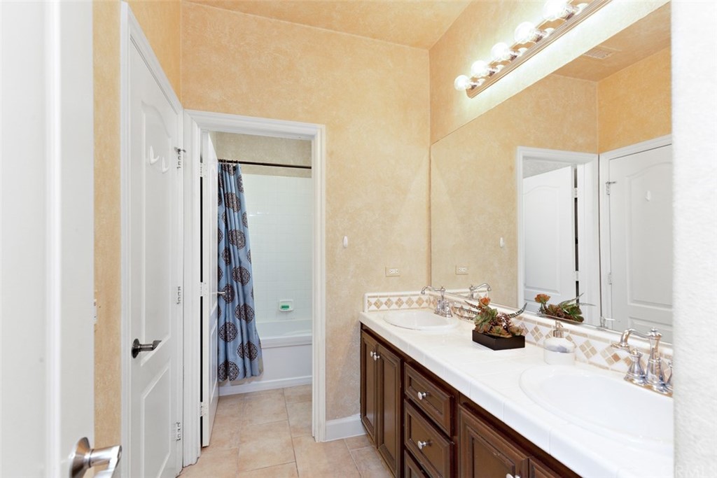 720 West Aster Place Santa Ana, CA 92706 - Photo 22 of 41 a bathroom with a double vanity sink and a mirror