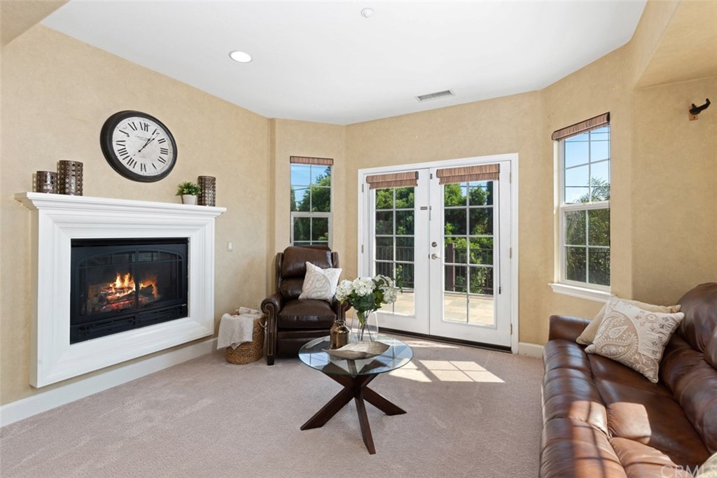 720 West Aster Place Santa Ana, CA 92706 - Photo 25 of 41 a living room with furniture a clock and a large window