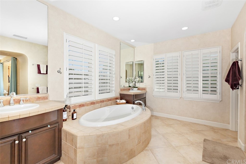 720 West Aster Place Santa Ana, CA 92706 - Photo 27 of 41 a bathroom with a tub sink and mirror