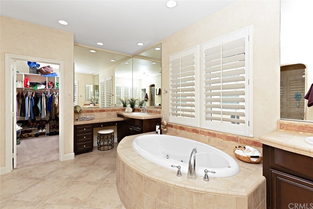 720 West Aster Place Santa Ana, CA 92706 - Photo 28 of 41 a bathroom with a tub a sink and a large mirror