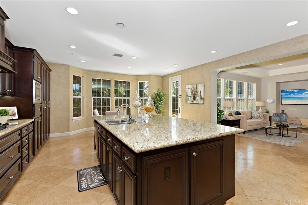 720 West Aster Place Santa Ana, CA 92706 - Photo 4 of 41 a kitchen with center island table and chairs