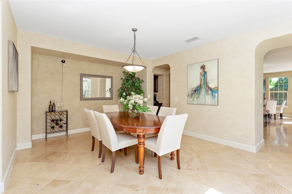 720 West Aster Place Santa Ana, CA 92706 - Photo 6 of 41 a dining room with furniture a chandelier and window