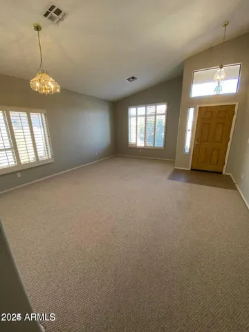 en empty room with windows and ceiling fan