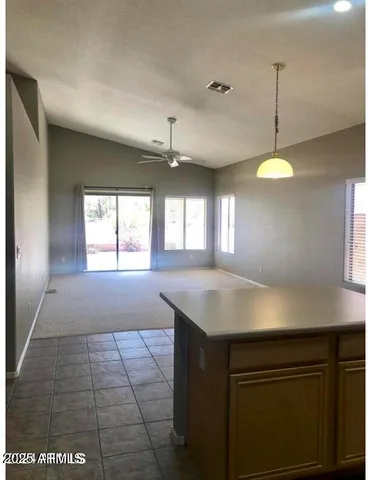 a kitchen with a sink window and cabinets