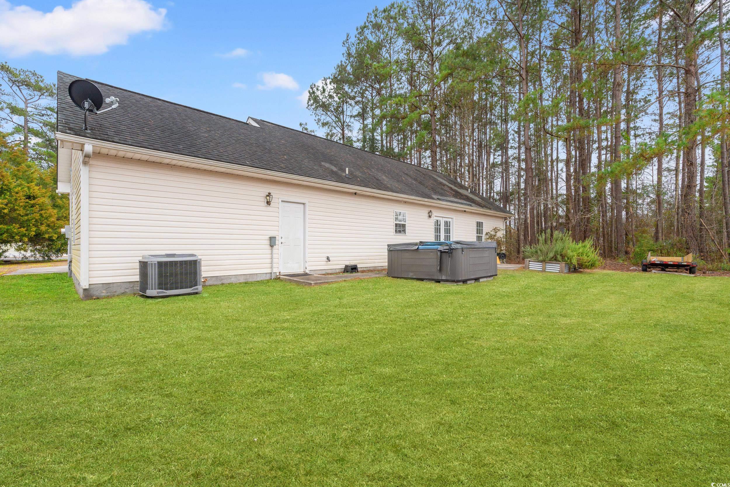3471 Spivey Street Loris, SC 29569 - Photo 28 of 31 Rear view of property featuring a hot tub, central