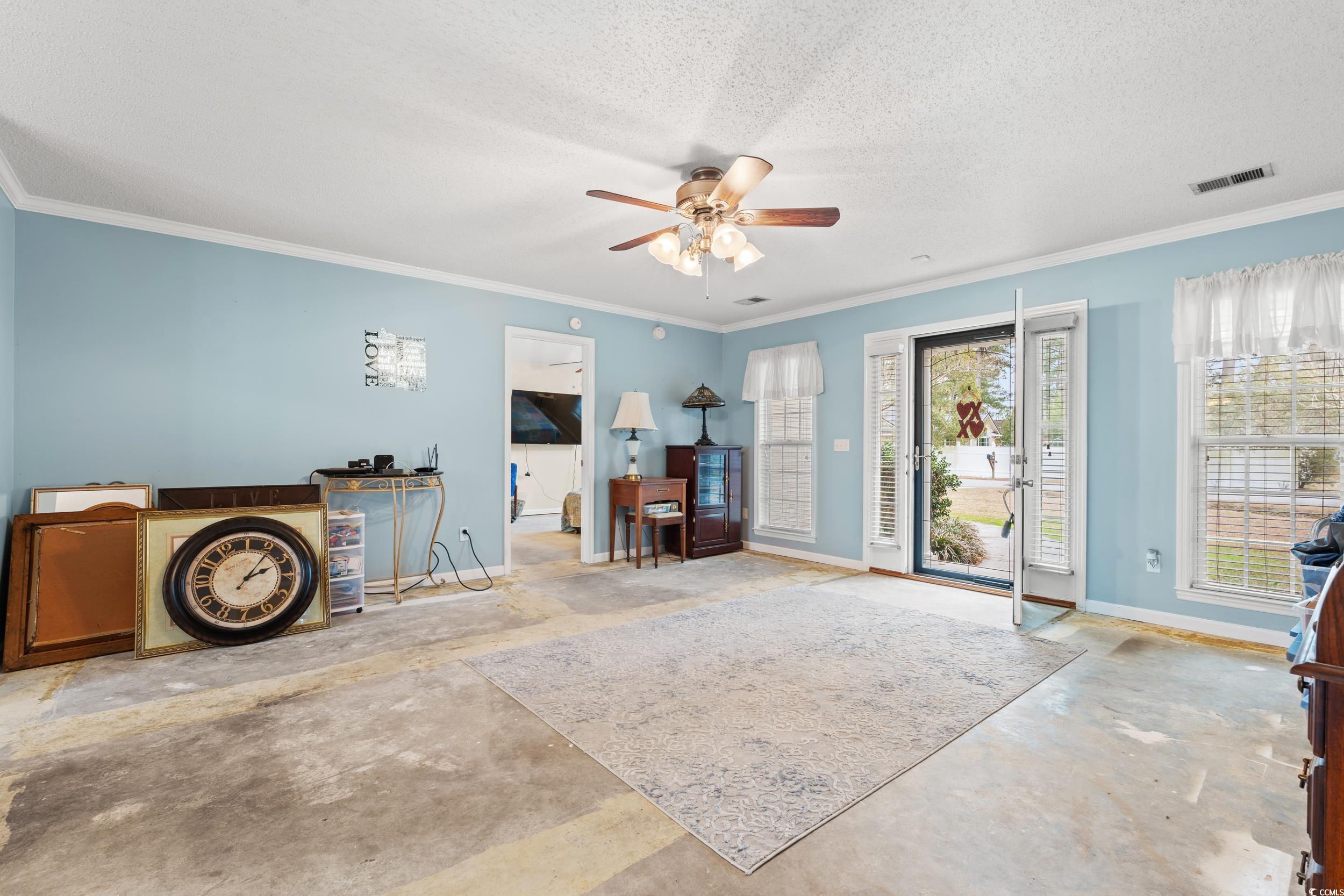 3471 Spivey Street Loris, SC 29569 - Photo 6 of 31 Living area featuring ceiling fan, crown molding,